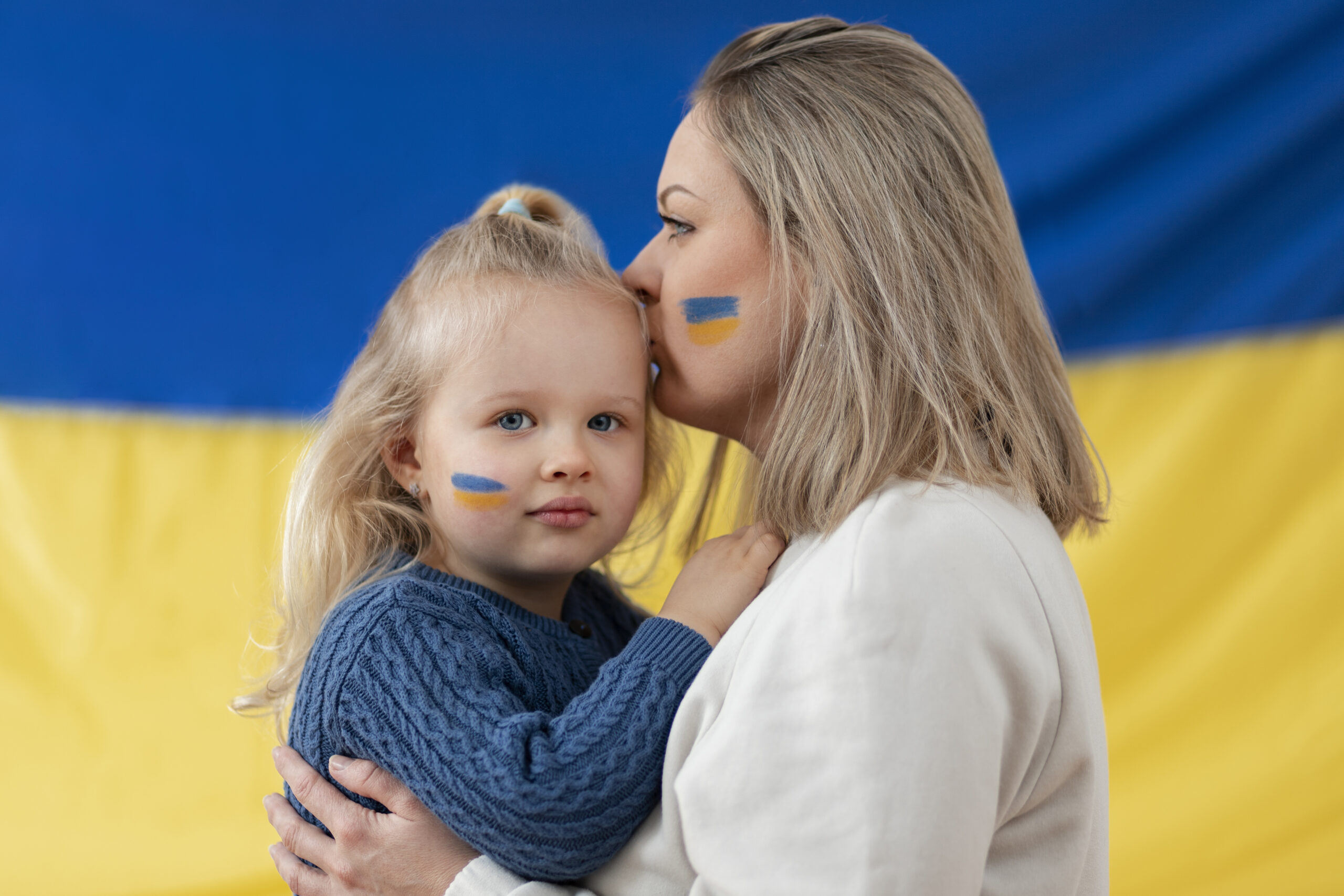 medium-shot-ukranian-mother-kissing-kid